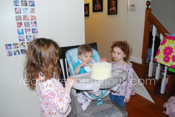 Sisters helping with the smash cake